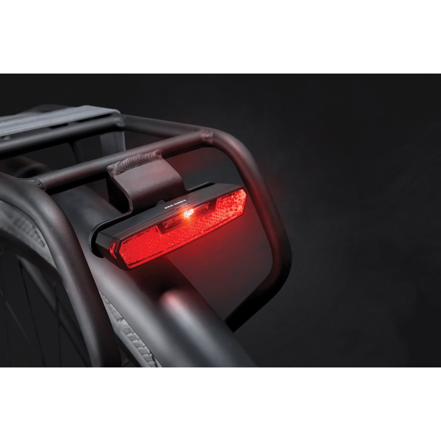 AXA Juno auto 50mm battery-powered rear bike light for pannier rack, supplied with 2 AAA batteries, visible from 500m